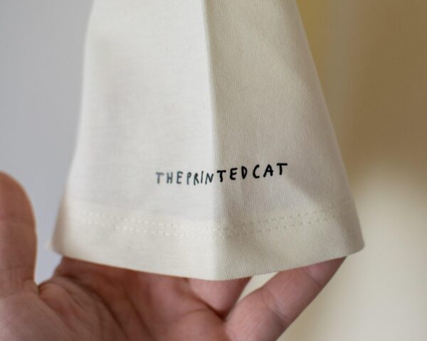 Cat gallery t-shirt | Hand screen printed on ecru/light yellow organic cotton tee with black and blue illustration of a cat judging cat art Top Womenswear Underwear Streetwear - Image 3